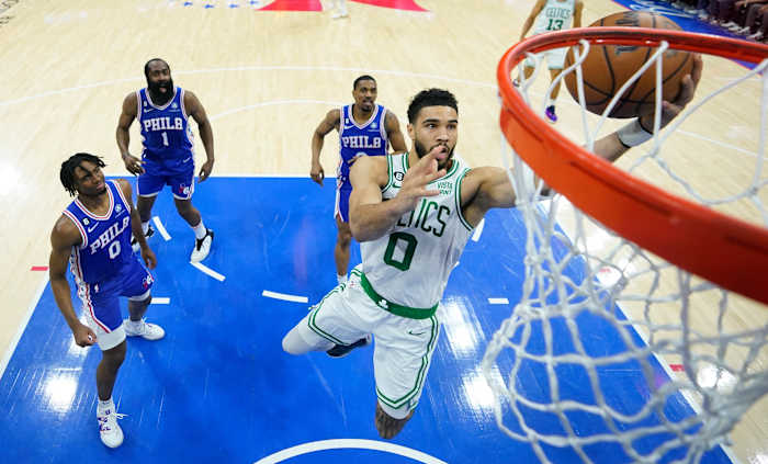 Celtics' Jayson Tatum, right, shoots against Philadelphia 76ers' Tyrese Maxey, left, James Harden and De'Anthony Melton during the Eastern Conference semifinals.